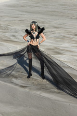 Girl in metal wig and in black retro-futuristic festival outfit. Burning man style photoset in...