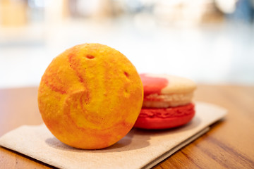 Close-up Colorful biscuit macaroons on wooden table and bokeh background.