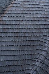 shingles on the roof. Wooden roof, shingled roof. Wooden tile. Roof of complex construction with dormer windows