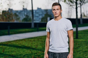 A man in shorts goes in for sports in a park in nature and a model running sneakers