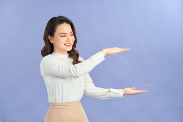 Beautiful young asian woman confident happy smile posing her empty hands for advertising use