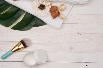 Fototapeta na wymiar Wooden decorative background green leaf cosmetics for soap bathroom accessories