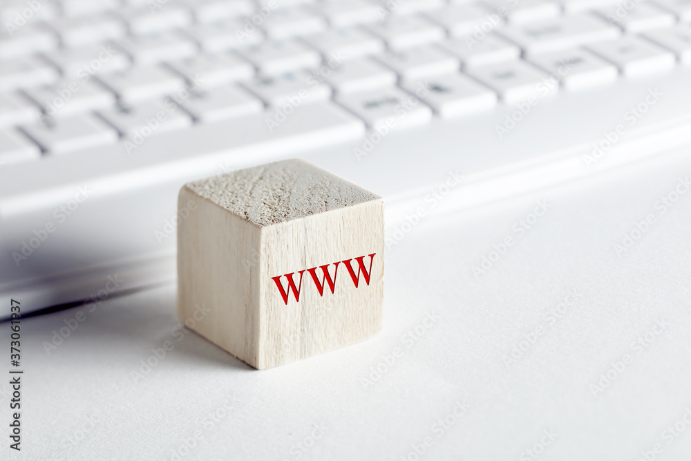 Wall mural the word www, world wide web written on wooden block with computer keyboard background.