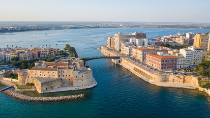 Beautiful panoramic aerial view photo from flying drone on Old medieval Aragonese Castle on sea channel, old town of Taranto city, Puglia (Apulia), Italy (Series) - obrazy, fototapety, plakaty