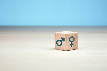 Male and female gender icons against blue background. Gender equality concept.