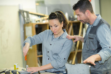 workman criticising his female colleague working with stone