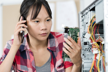 female computer technician engineer speaks on the phone