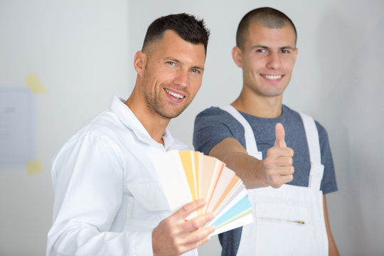young house painter and decorator with thumbs up