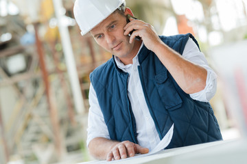 worker construction engineer on the phone