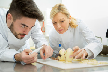 couple of confectioners making a dessert