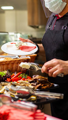 Food service in the hotel or restaurant. The chef prepares food in the restaurant and packs it in disposable dishes