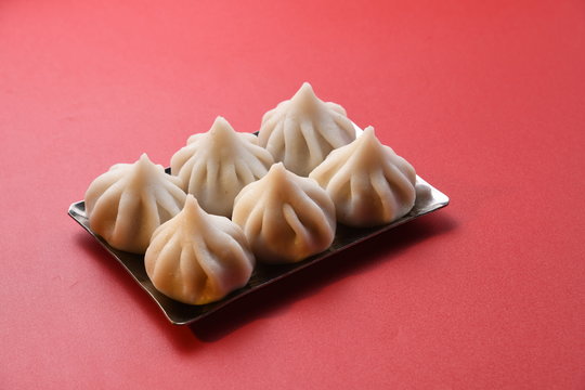 modak indian ganesh festival recipes make on ganesh chaturthi / utsav modak photo on black baground 