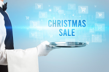 Waiter serving CHRISTMAS SALE inscription, online shopping concept