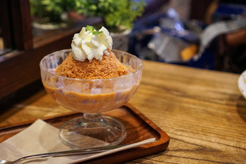 Thai tea and 'Bua loy' Bingsu. A bowl of Thai tea shaved ice served with rice ball called 'Bua loy'.
