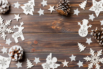 Top view of Christmas decorations and toys on wooden background. Copy space. Empty place for your design. New Year concept