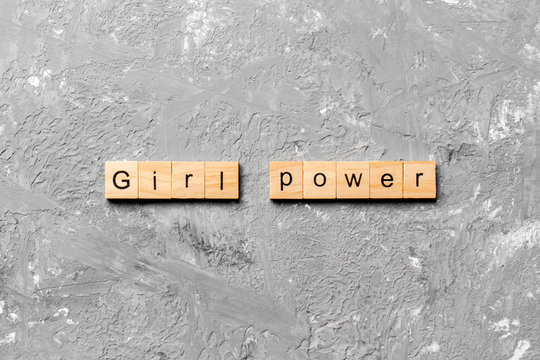 Girl Power word written on wood block. Girl Power text on cement table for your desing, concept