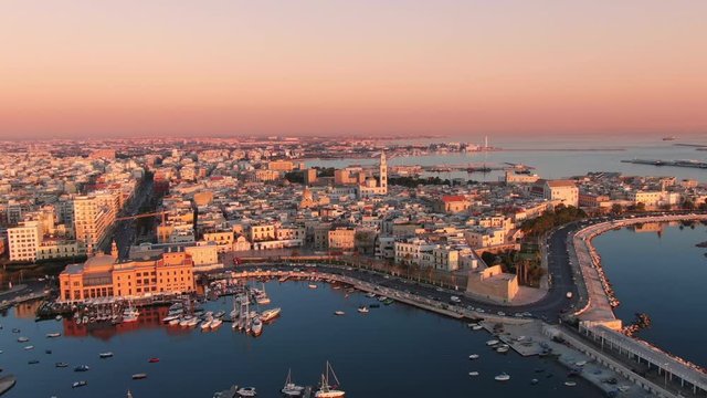 bari aerial view at sunrise,drone flying orbit over seafront waterfront with old city in the background,apulia italy