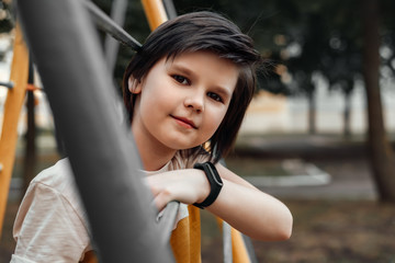 Obraz premium Portrait of a happy little boy 10-12 years old in the playground