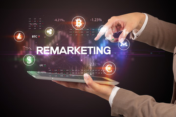 Close-up of a touchscreen with REMARKETING inscription, business opportunity concept