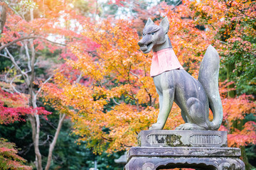 Fox sculpture in Fushimi Inari-taisha shrine in fall autumn season, located in Fushimi-ku. landmark...