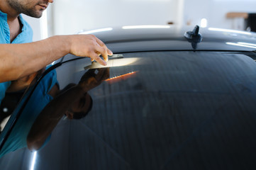 Male wrapper installs car tinting, tuning service