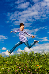 Girl jumping, running against blue sky
