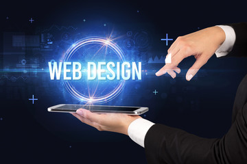 Close-up of a touchscreen with WEB DESIGN inscription, new technology concept