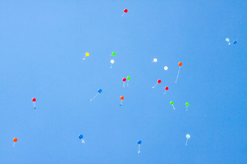 Colorful ballons with letters flying in the blue sky