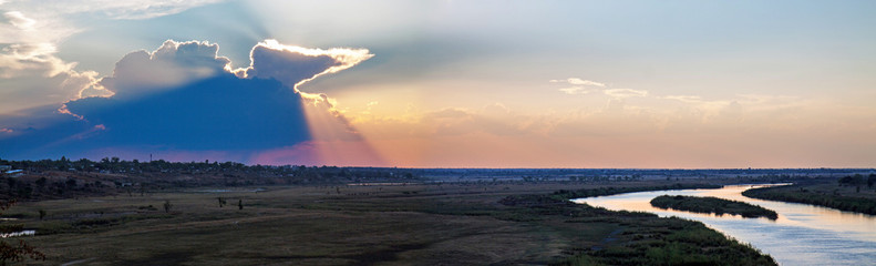 Thunderstorm developing at sunset over the Kavango river valley near Rundu on the border between...