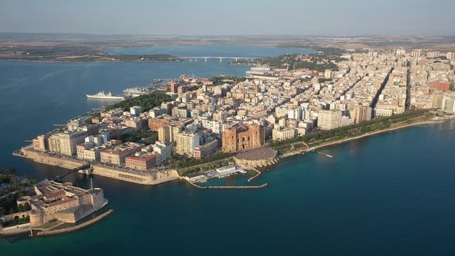 Beautiful panoramic aerial 4K video from flying drone on Old medieval Aragonese Castle on sea channel, old town of Taranto city, Puglia (Apulia), Italy (Series)