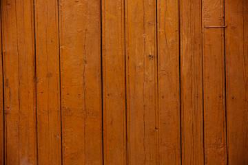 intage red wood background texture with knots and nail holes. Old painted wood wall. Red abstract background. Vintage wooden dark horizontal boards. Front view with copy space