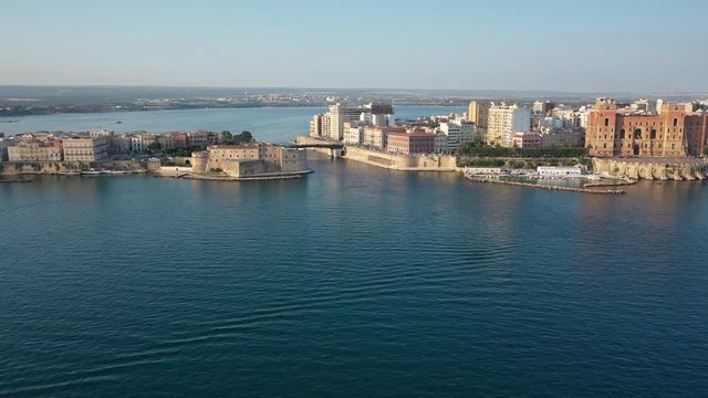 Beautiful panoramic aerial 4K video from flying drone on Old medieval Aragonese Castle on sea channel, old town of Taranto city, Puglia (Apulia), Italy (Series)