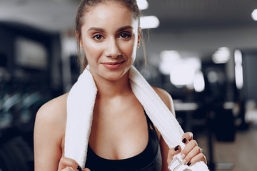 Portrait of a young sporty caucasian woman training in a fitness club