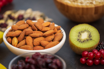 Fruits and Breakfast with Whole grains and nuts, yogurt mix with Cherry , banana, avocado in the wooden table. Breakfast for Health and Diet concept