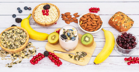 Fruits and Breakfast with Whole grains and nuts, yogurt mix with Cherry , banana, avocado in the wooden table. Breakfast for Health and Diet concept