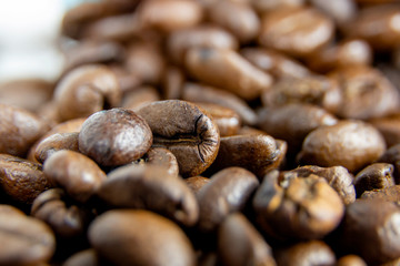 Fototapeta premium Detail of brown coffee beans on white background