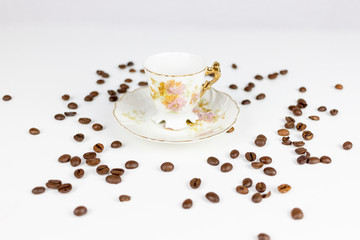 Cup of coffee or porcelain tea on white background with coffee beans