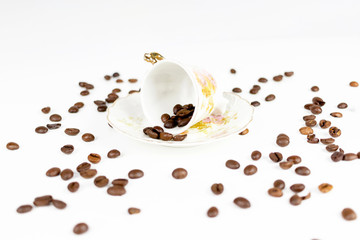 Cup of coffee or porcelain tea on white background with coffee beans