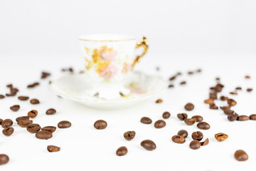 Cup of coffee or porcelain tea on white background with coffee beans