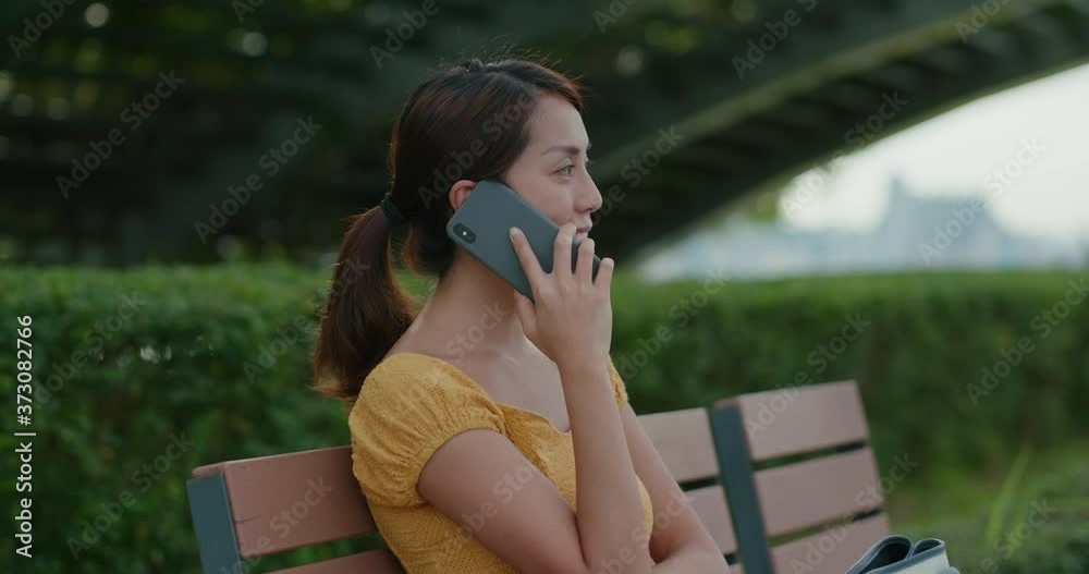 Poster Woman talk on cellphone at park