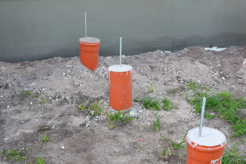 Pillar foundation of terrace made of pipes filled with concrete and steel reinforcement outdoors. DIY concept.
