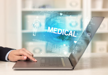 Obraz premium Doctor working a health check with MEDICAL inscription, recording medical test results
