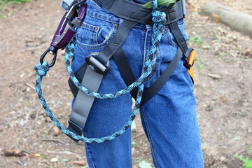 Close-up of female climber with climbing gear equipment on belt for safety. Active healthy lifestyle concept.
