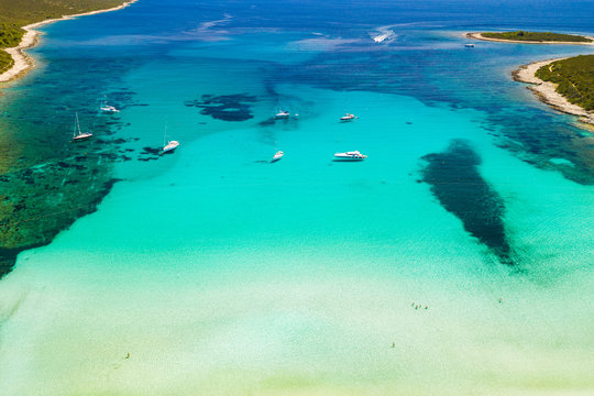 Amazing coastline in Croatia. Turquoise lagoon on Sakarun beach on Dugi Otok island, yachts and sailboats anchored in blue sea. Adriatic paradise. Drone aerial. © ilijaa