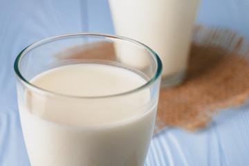 Glass of milk on table close up