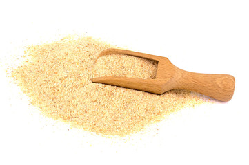 Pile of breadcrumbs and spoon isolated on white