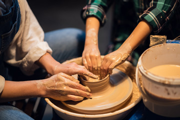 a pottery lesson at an art school is taught by a young girl a Potter for a cute child.