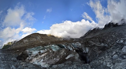 Fototapeta na wymiar Glacier with blue ice in the Swiss Alps in Valais as a panorama with a bright blue sky