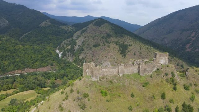 Aerial view of Maglic medieval fortress. The castle is located a top a hill around which the Ibar river in Serbia. The fortress consist of seven towers and one dungeon tower connected with walls