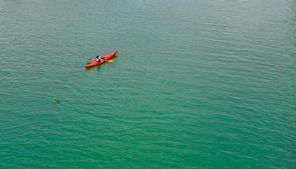 Fototapeta premium Top view of a kayaker making a break on the Guadalquivir river in Seville, Andalusia, Spain. 